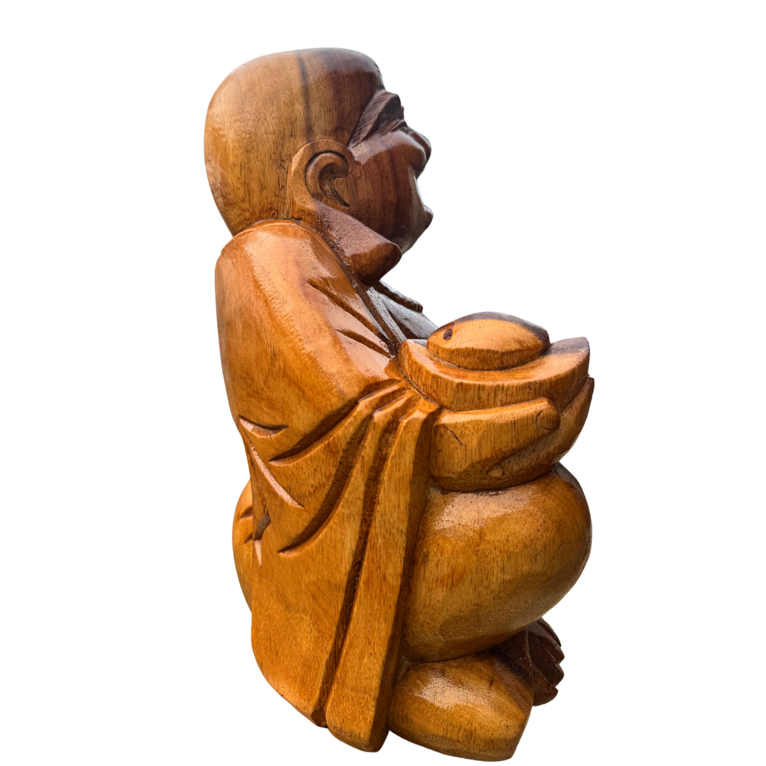 Wooden statue of a seated figure holding a bowl on a white background