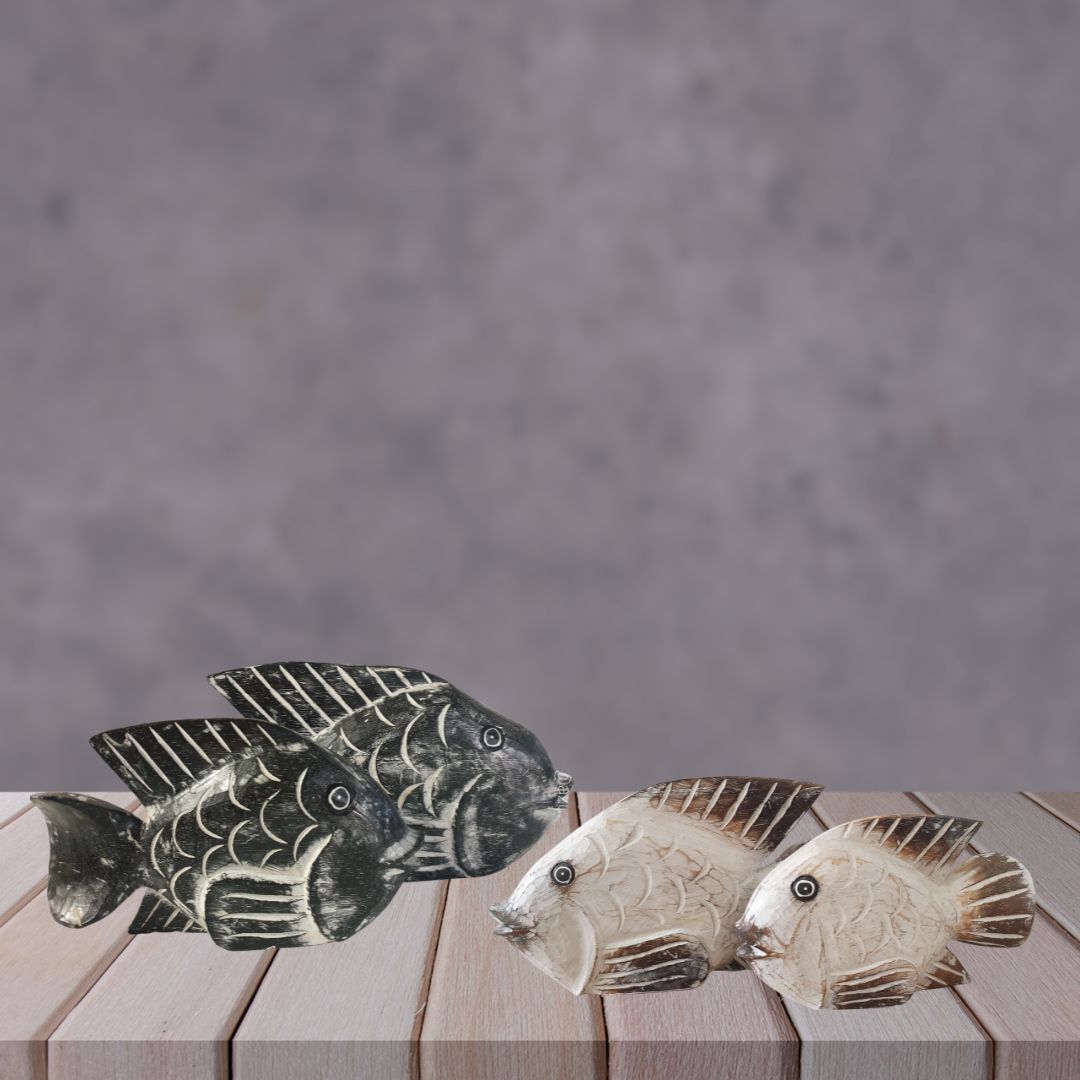 Decorative fish figurines on a wooden surface with a gray background