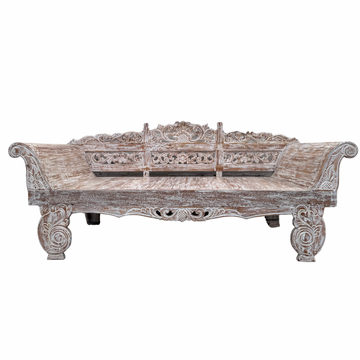 Carved wooden bench with intricate patterns on a white background