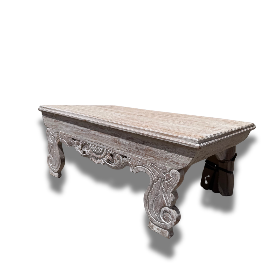 Decorative wooden table with intricate carvings on a white background