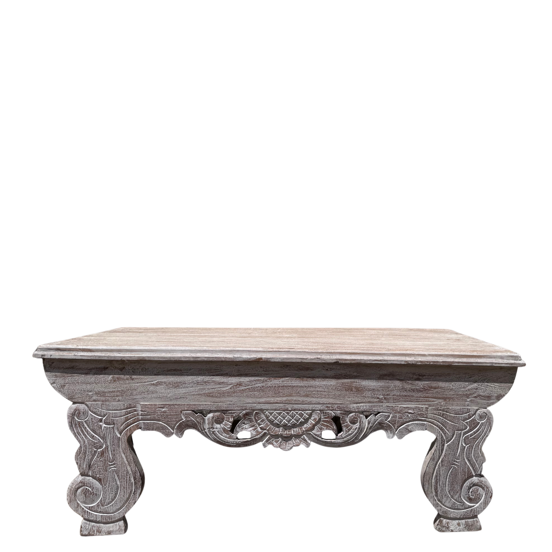 Decorative wooden table with intricate carvings on a white background