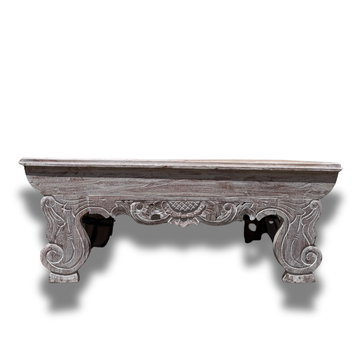 Decorative wooden coffee table  with intricate carvings on a white background
