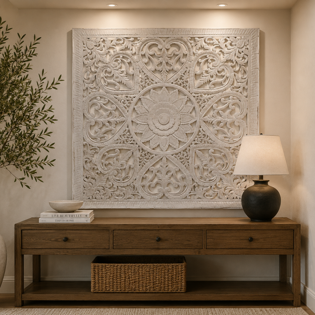 Panel in white mounted above a timber console table with a black ceramic lamp and olive branch in a warm neutral entryway