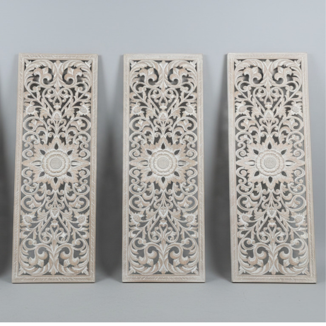 three whitewash hand-carved MDF wall panels displayed side by side in portrait orientation, showing intricate Balinese floral scrollwork, acanthus leaf motifs and central flower medallion detail against a light grey background