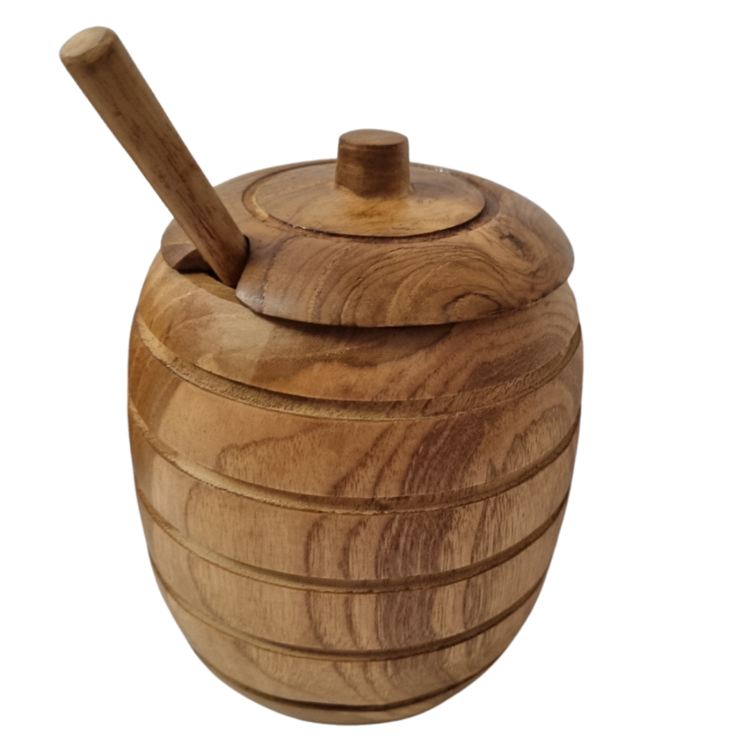 woode jar with lid and sppon on a white back ground