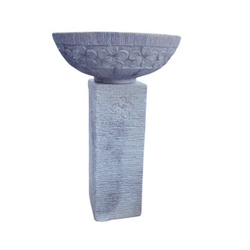 Decorative concrete destal with bowl on a white background birdbath