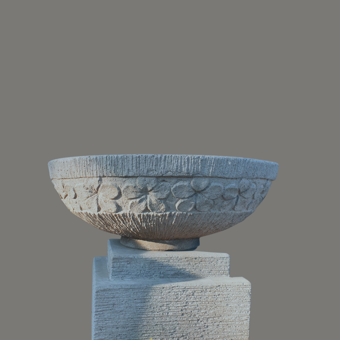 Decorative bowl on a pedestal with floral patterns against a gray background