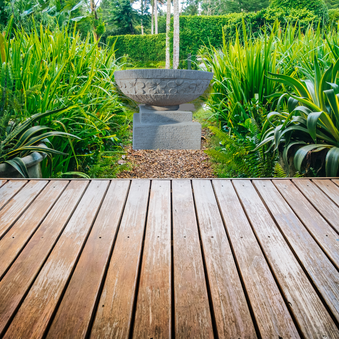  bowl sculpture in a garden with wooden deck in foreground