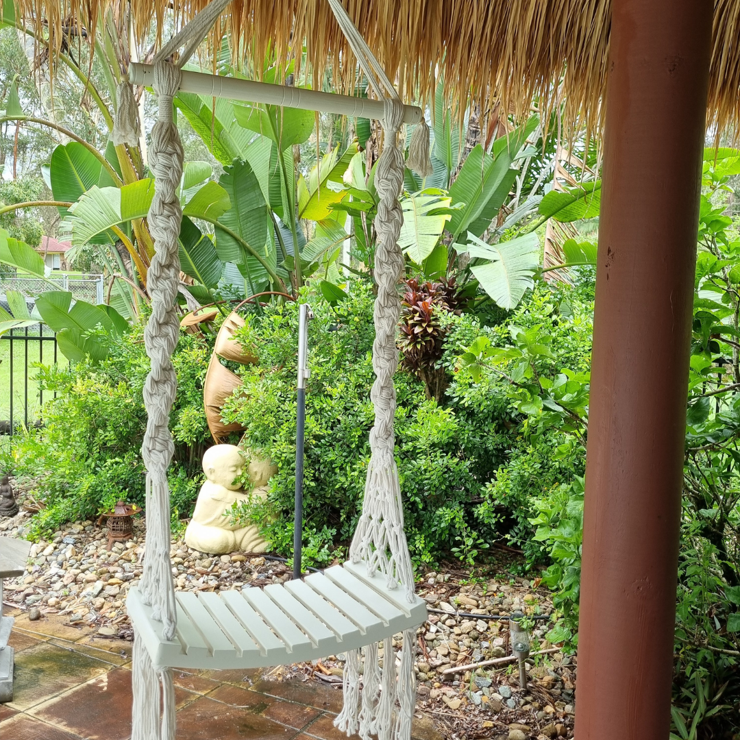 Solid wooden seat, designed with intricate patterns and tassels.