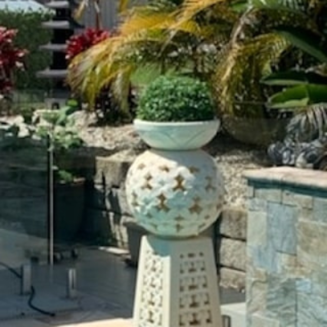 Decorative outdoor planter with a spherical design in a garden setting