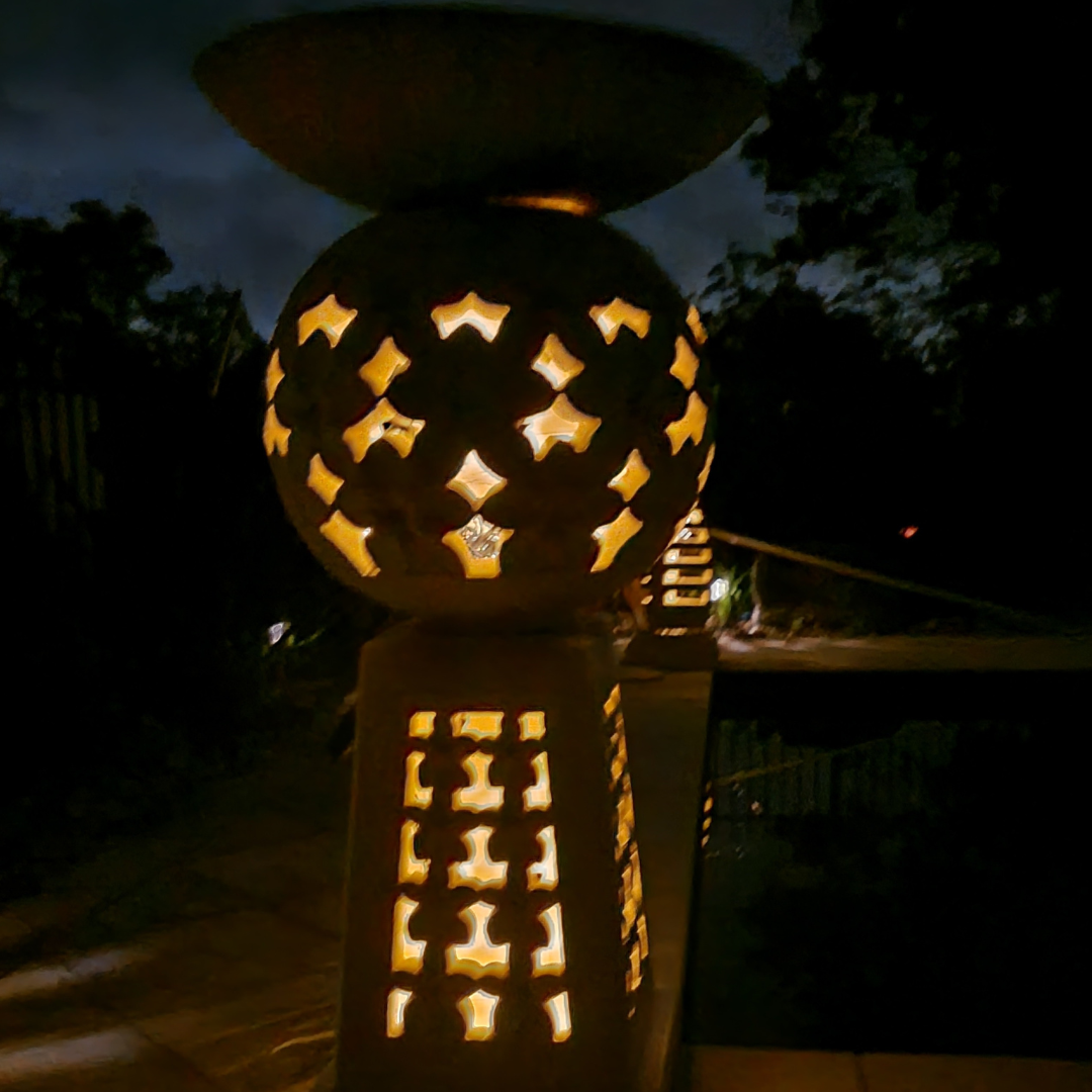 birdbath planter stand with solar lights set in a garden 