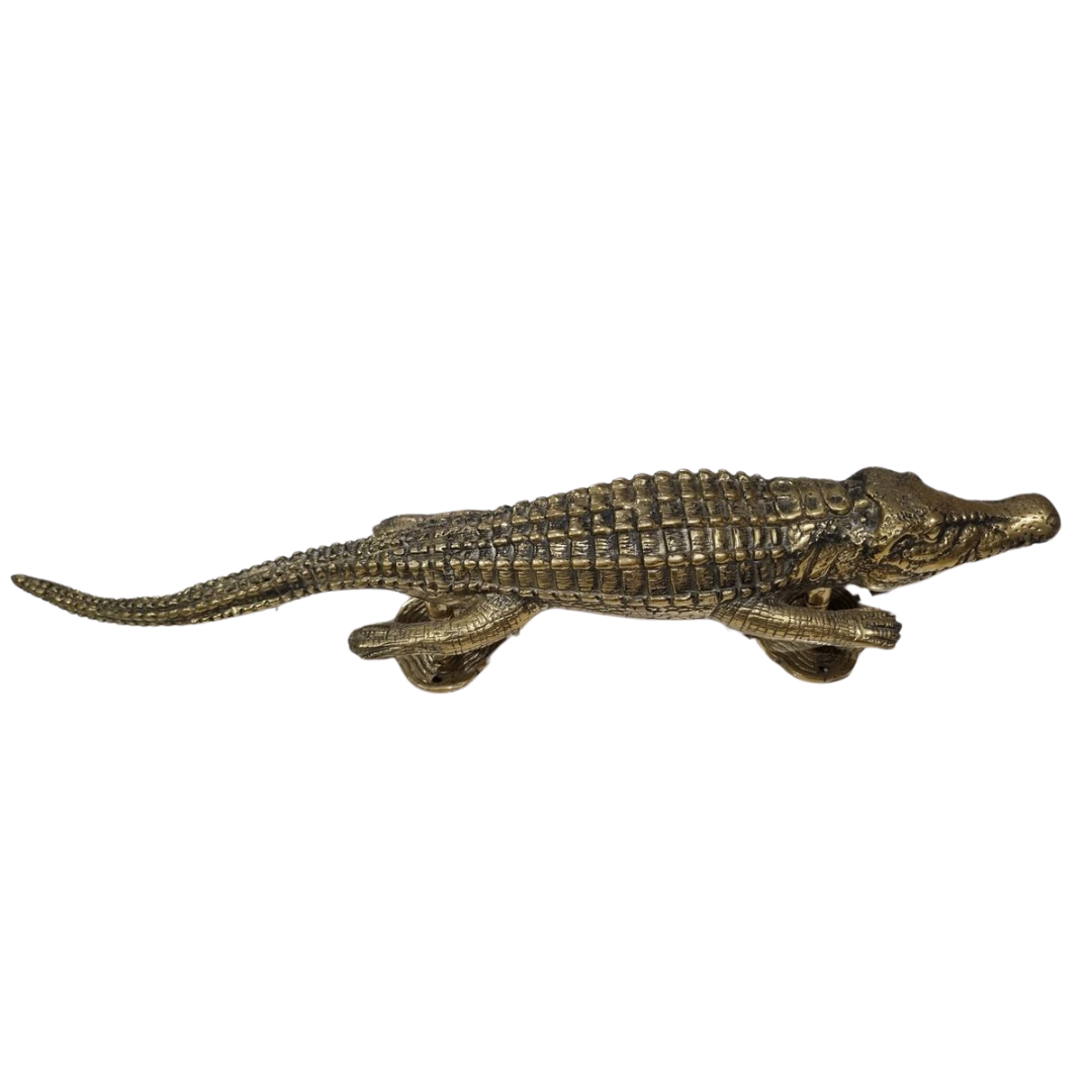 Solid brass crocodile door handle – close up detail shot showing textured scale carving and polished gold finish – decorative brass hardware on white background