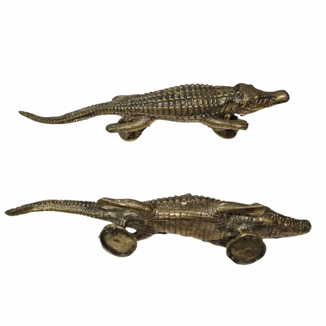 Two solid brass crocodile door handles – polished gold finish – handcrafted brass hardware on white background
