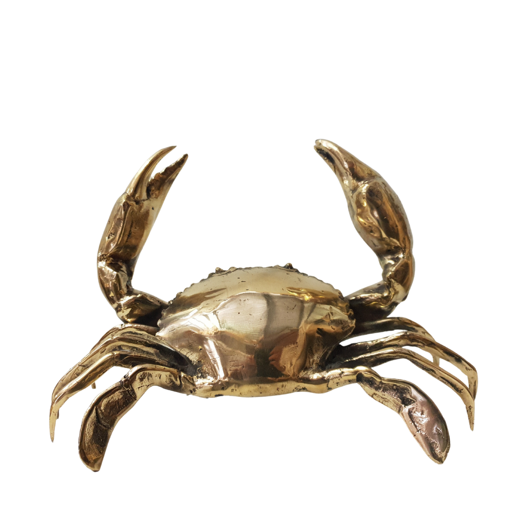 Gold crab figurine on a white background