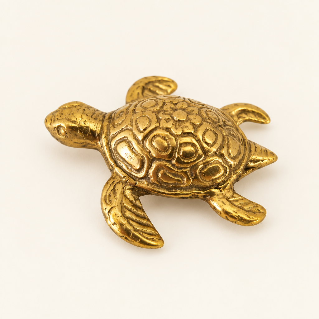 Small gold turtle ornament viewed from the side and top view 