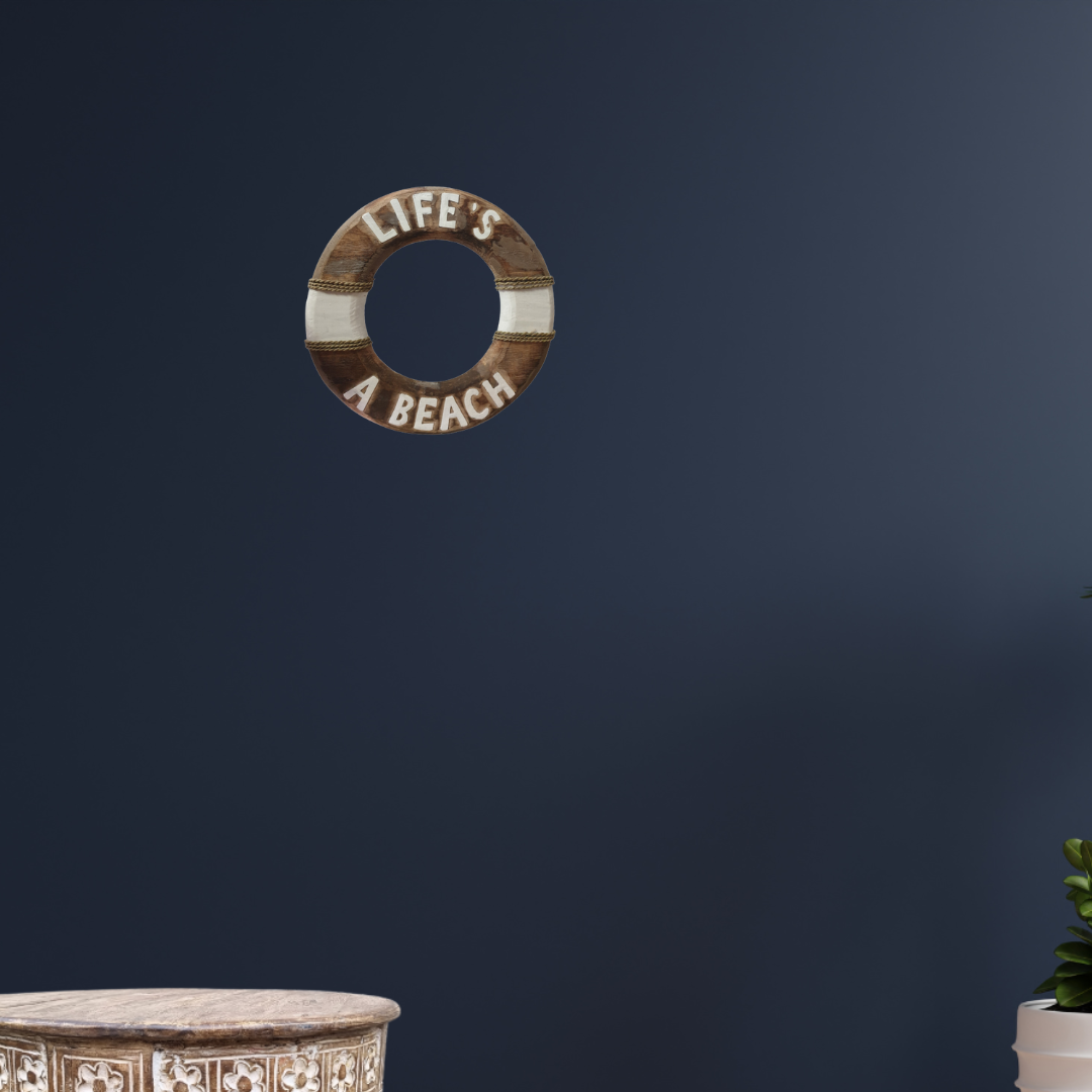 Decorative life buoy with 'Life's a Beach' text on a dark blue wall.