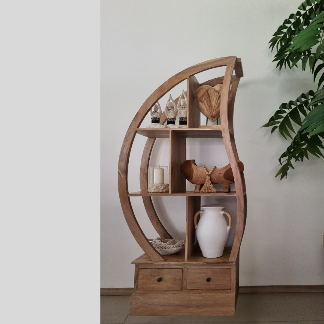 Wooden circular shelf with decorative items against a light wall.