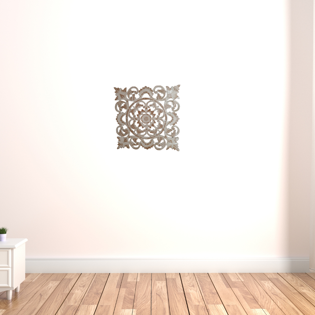 Decorative wall art on a plain wall with wooden flooring