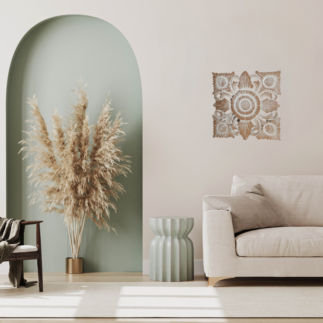 Modern living room with a beige sofa, decorative plant, and wall art.