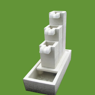 White stone water fountain on a green background