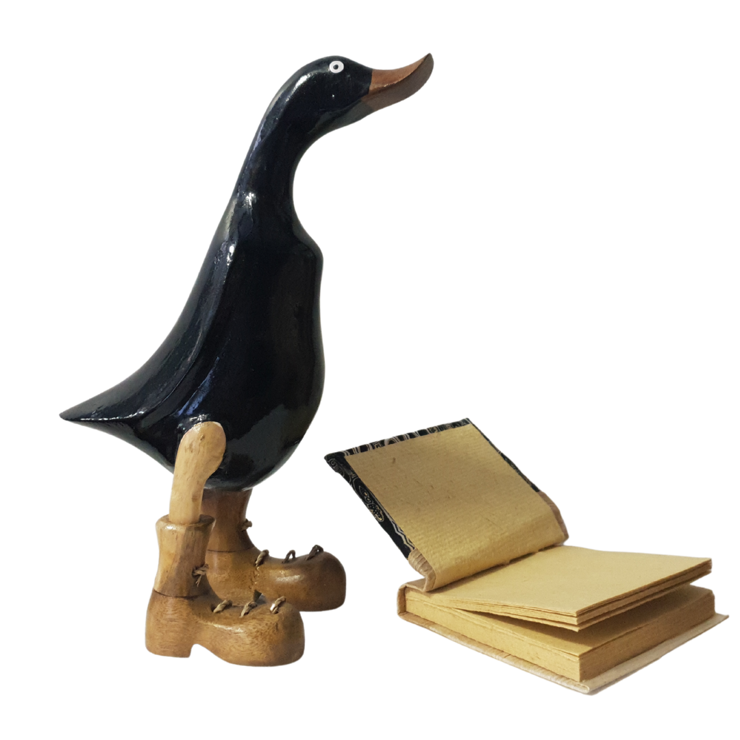 Black figurine set with a book on a white background