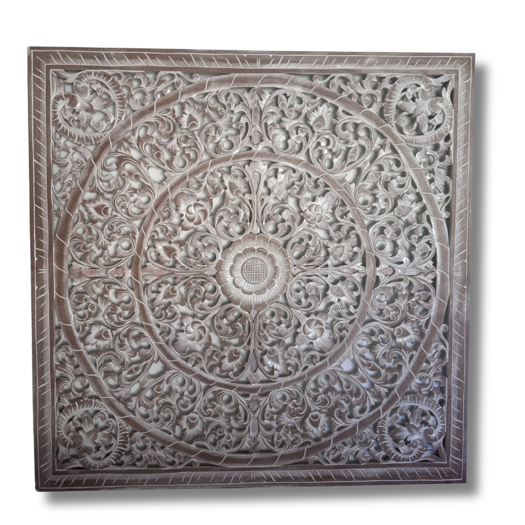 Decorative wall panel with intricate carvings on a white background