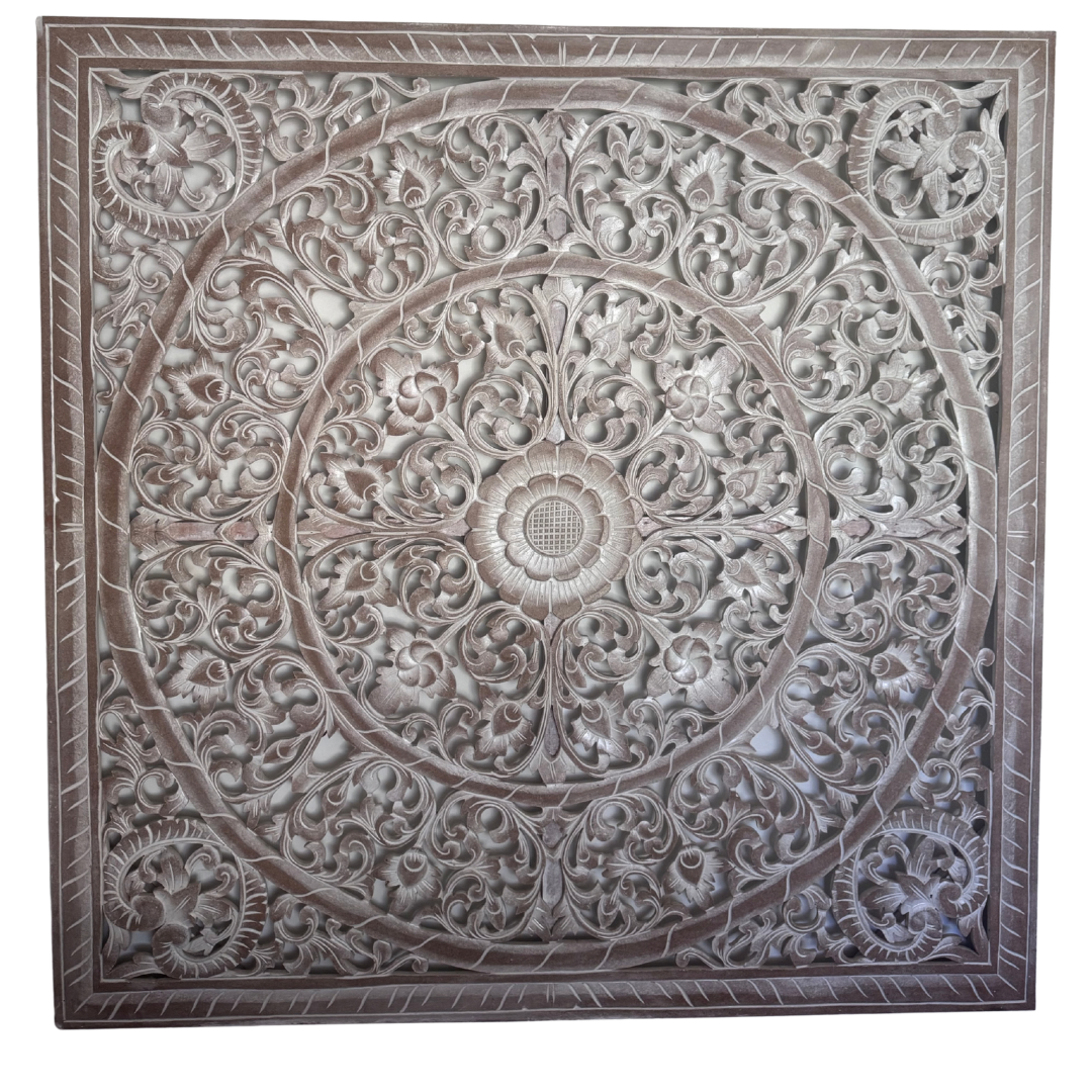 Decorative wall panel with intricate carvings on a white background