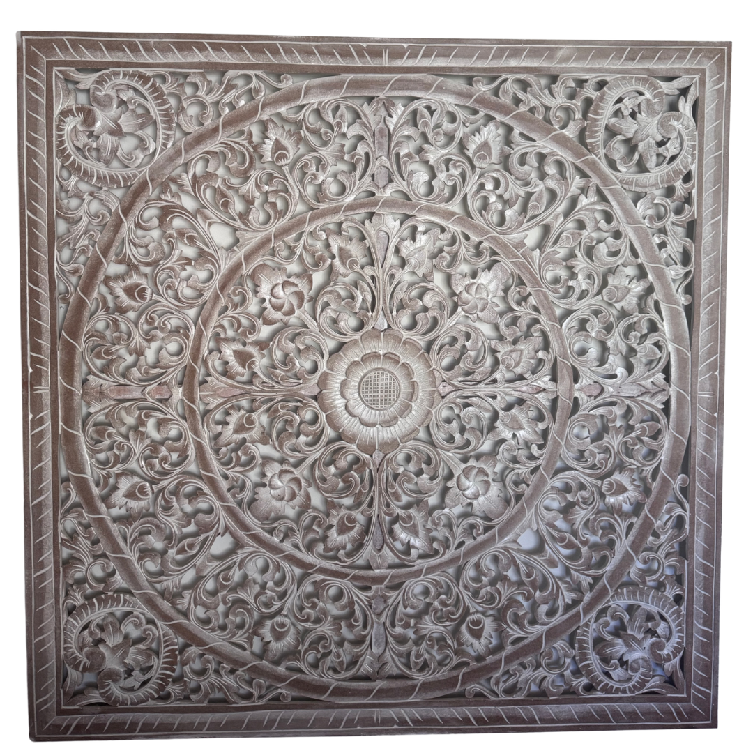 Decorative wall panel with intricate carvings on a white background