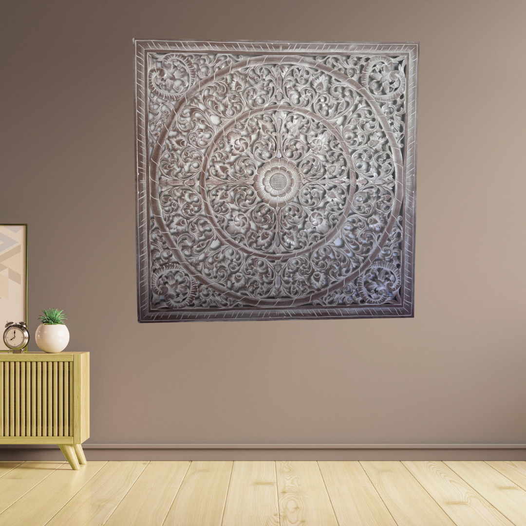 Decorative wall art with intricate patterns on a beige wall.