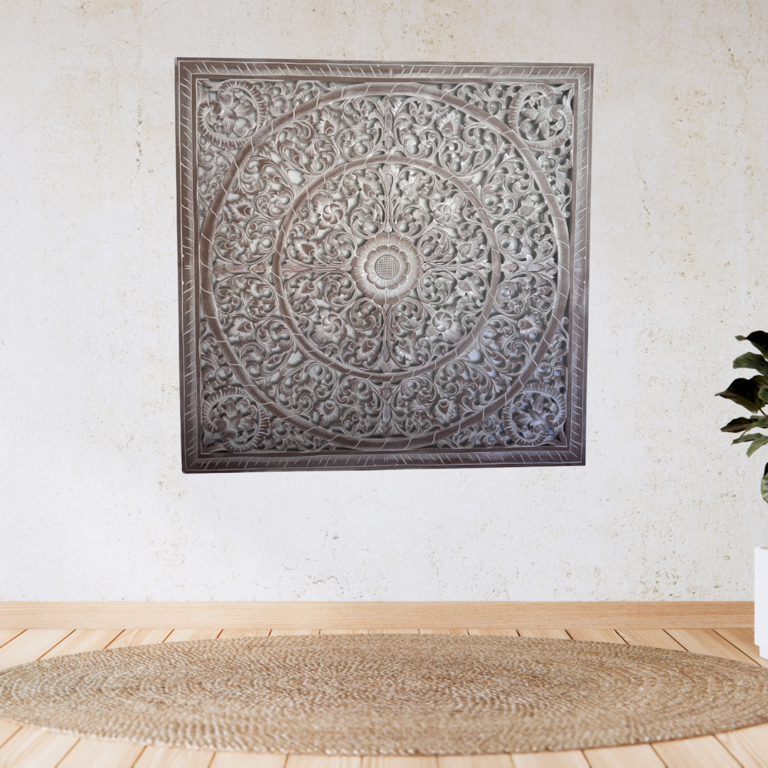 Decorative wall panel with intricate patterns on a white wall.