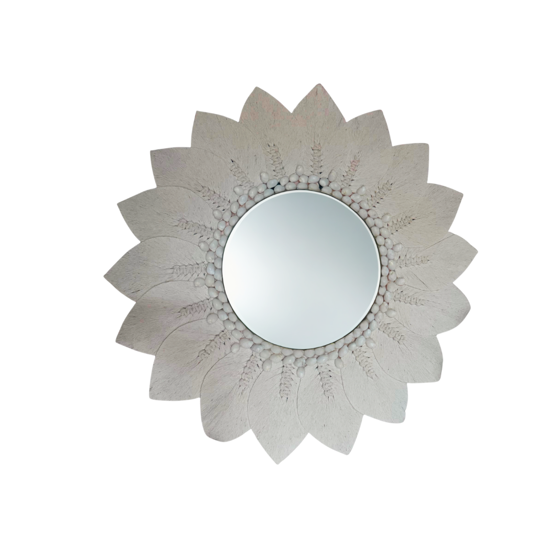 Decorative wall mirror with floral design on a white background