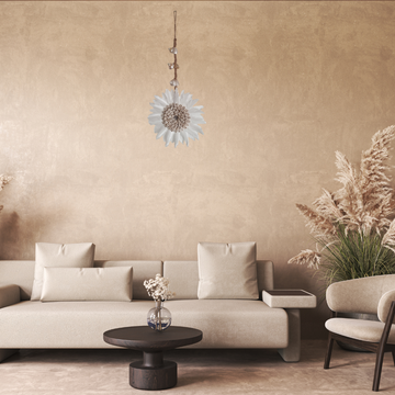 Modern living room with beige sofa, round coffee table, and decorative elements.
