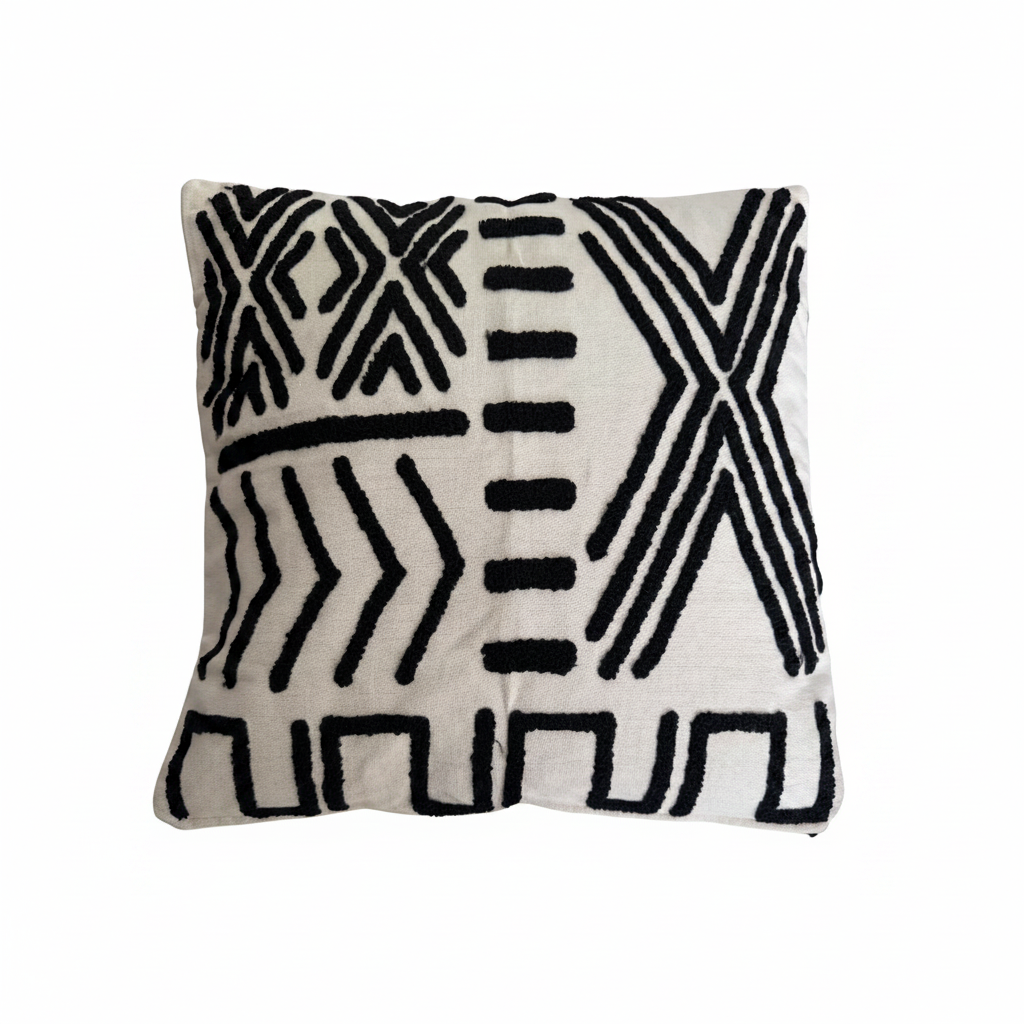 A square throw pillow with a black and off-white geometric pattern, featuring textured vertical tufting.