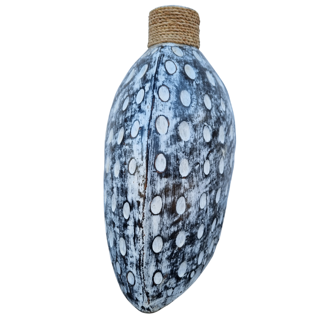 Dome-shaped pot with black and white wash distressed finish and raised oval dots, natural rope collar at the neck, white background