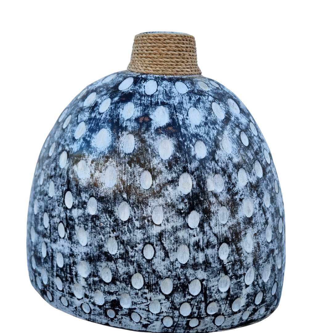A ceramic table top vase with a black and white wash finish and a jute rope detail on the top.