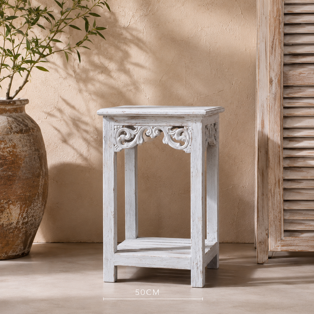 Small 50cm whitewash timber pedestal stand styled beside a terracotta vase with greenery and timber louvre panel against a textured beige wall | Azure Decor