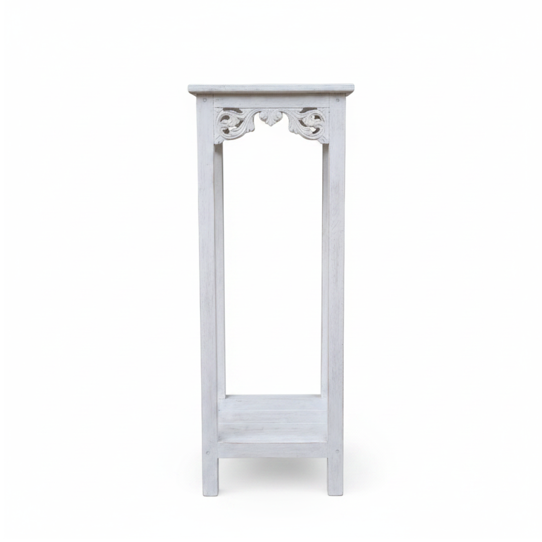 Distressed white wooden display stand with carved scroll apron detail, square top and open slatted lower shelf, shown against a plain white background | Azure Decor