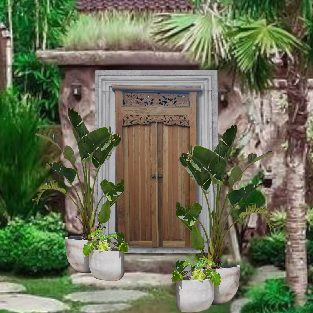 Wooden door with decorative carvings in a lush garden setting