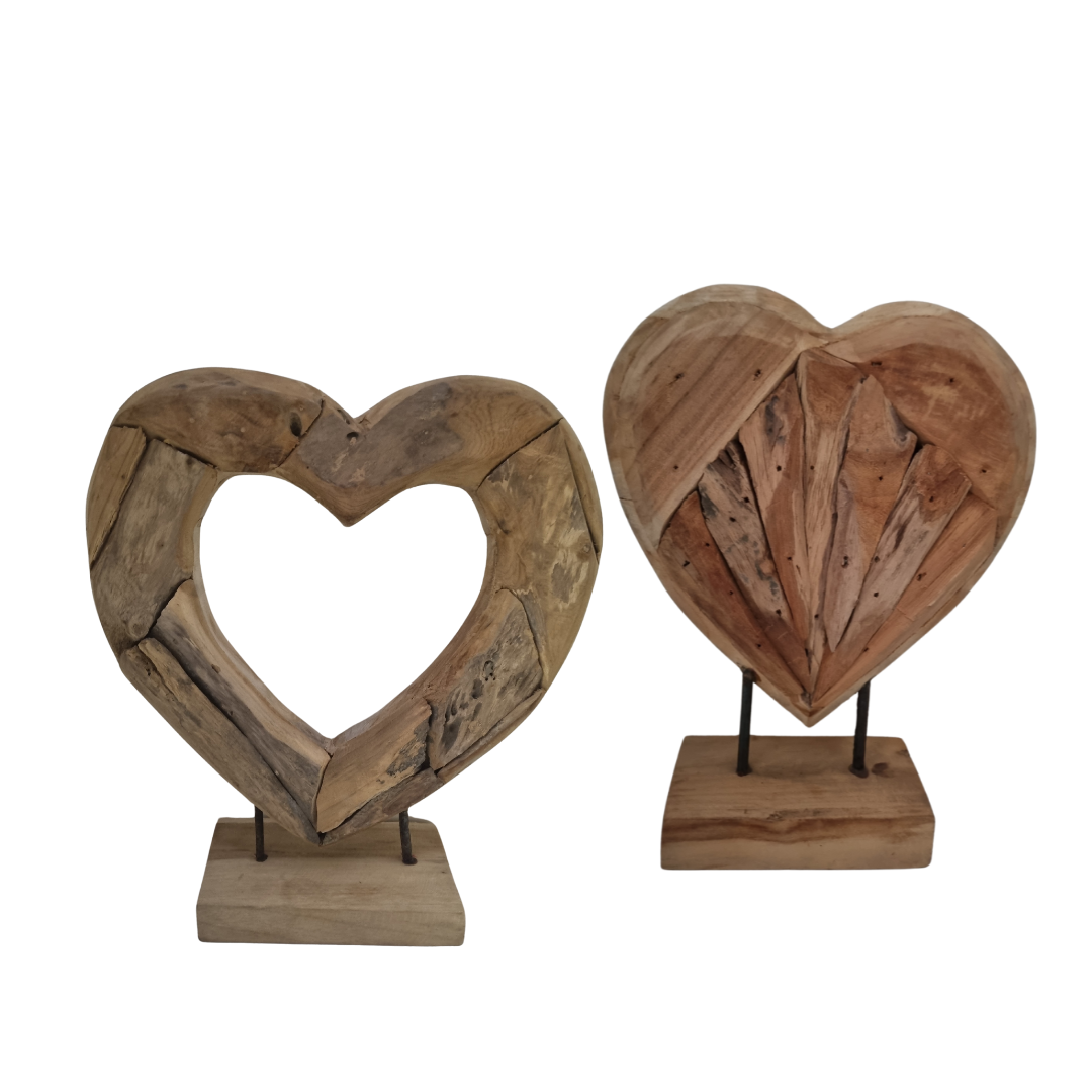 Handcrafted driftwood heart teak sculptures — open heart and solid radiating heart styles on rectangular teak bases, natural reclaimed wood