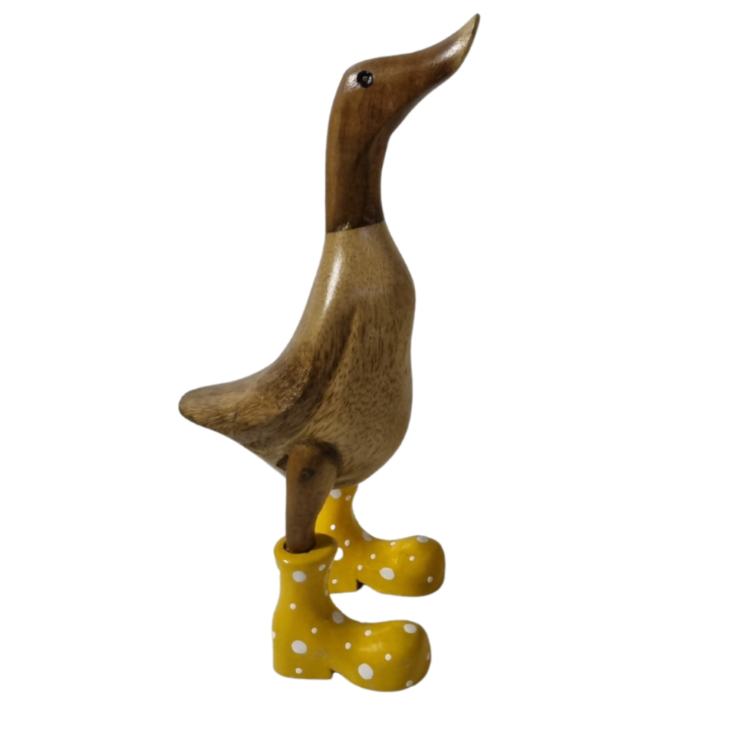 wooden statue set to theright on a Ducks Spoted Boots white background 