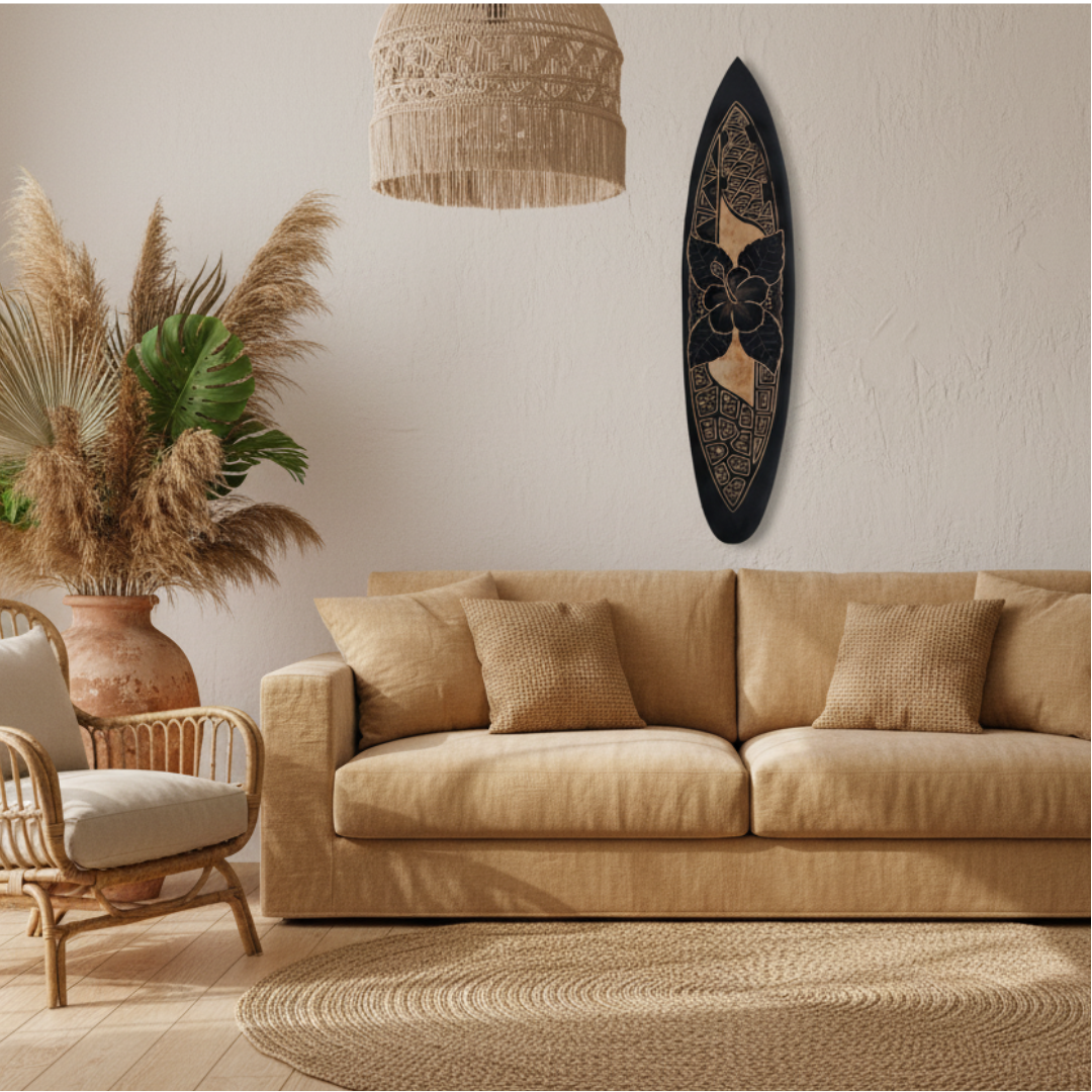 Hand-carved surfboard wall art in black featuring a large hibiscus bloom, wave scale pattern and geometric turtle shell carvings