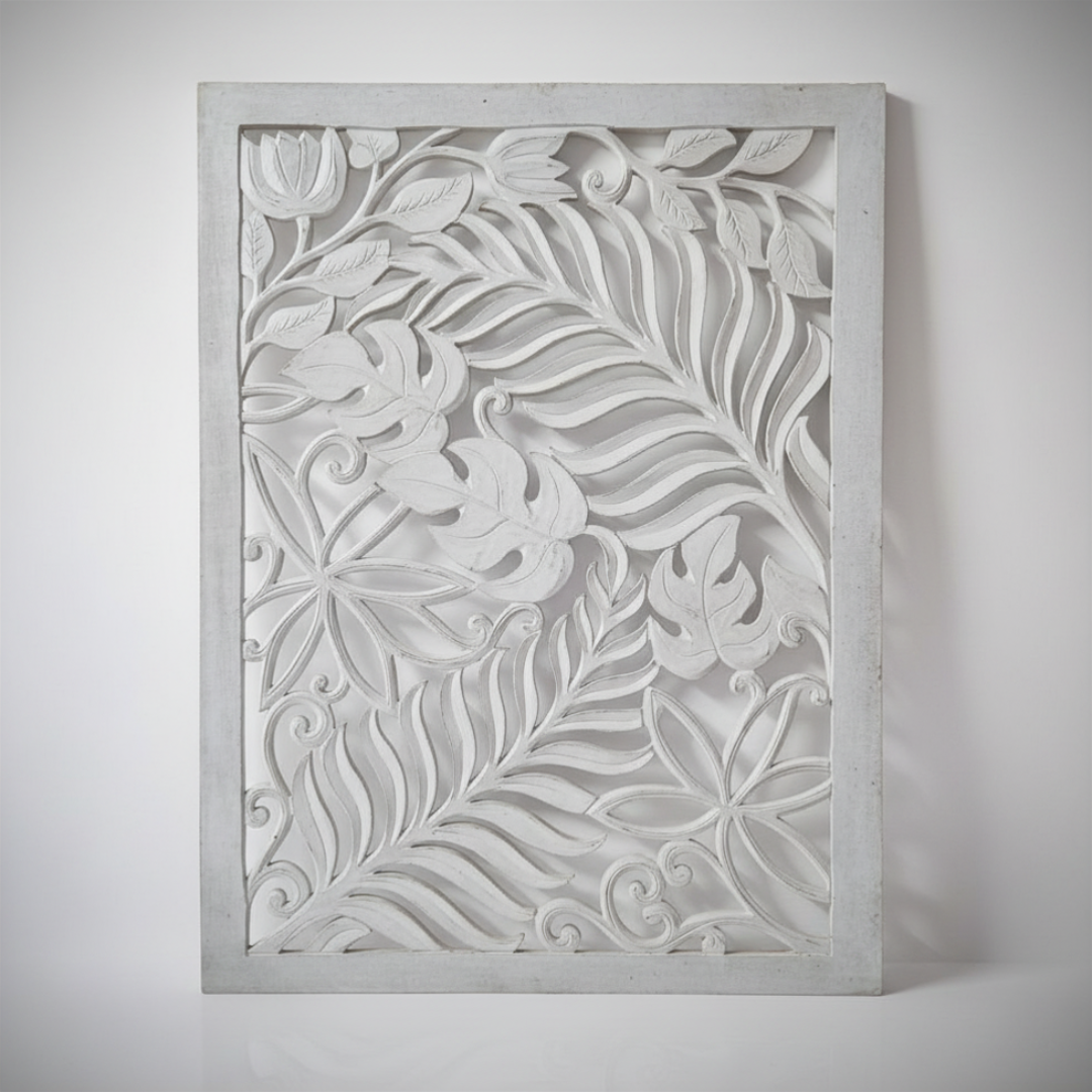 Portrait product shot of a whitewash hand-carved timber wall panel featuring layered fern fronds, monstera leaves, tulip blooms, star flowers and decorative scroll details on a neutral grey background