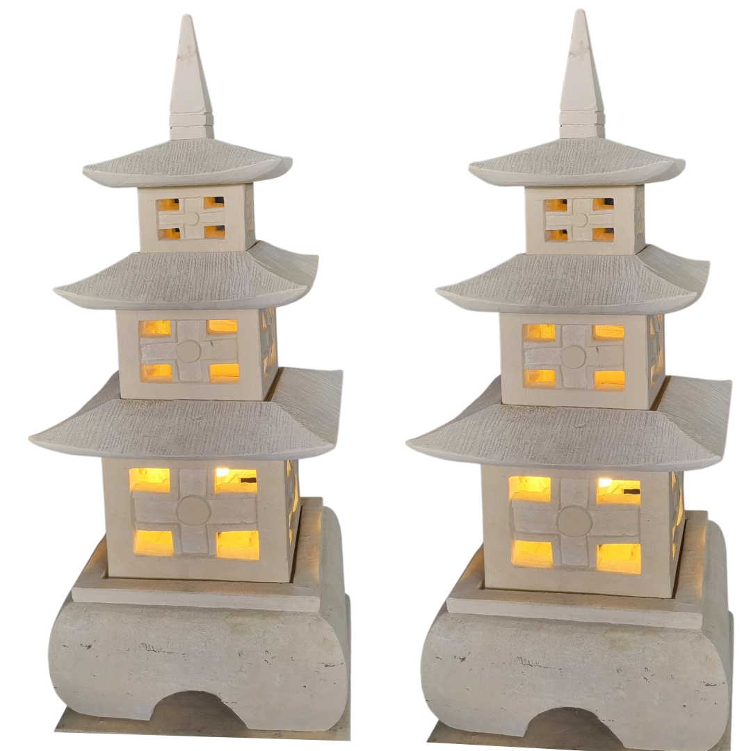 Two stone pagoda lanterns with warm amber-glowing windows shown front and angled view, white background