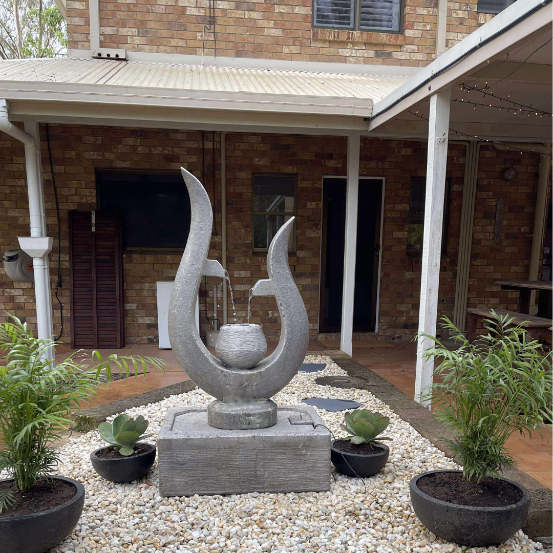 Decorative outdoor fountain with plants in a garden setting
