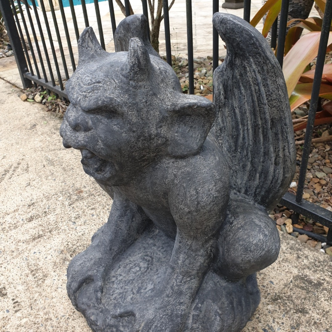 A rustic style gargoyle garden statue made from reinforced concrete and glass fiber, displayed in a natural outdoor setting.