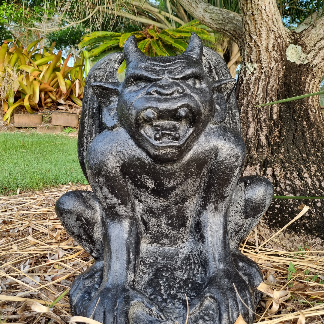 A rustic style gargoyle garden statue made from reinforced concrete and glass fiber, displayed in a natural outdoor setting.