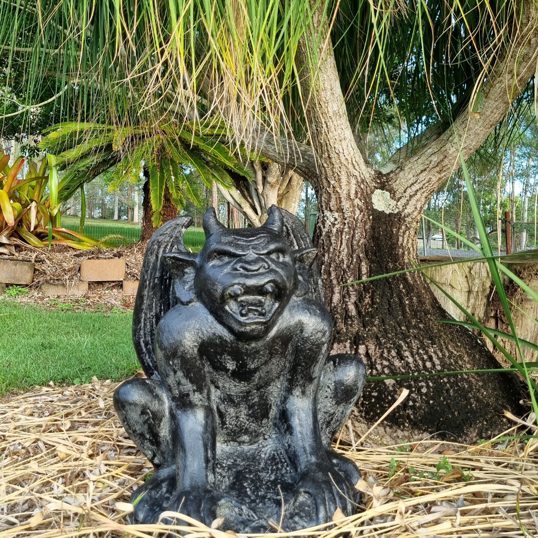 A rustic style gargoyle garden statue made from reinforced concrete and glass fiber, displayed in a natural outdoor setting.