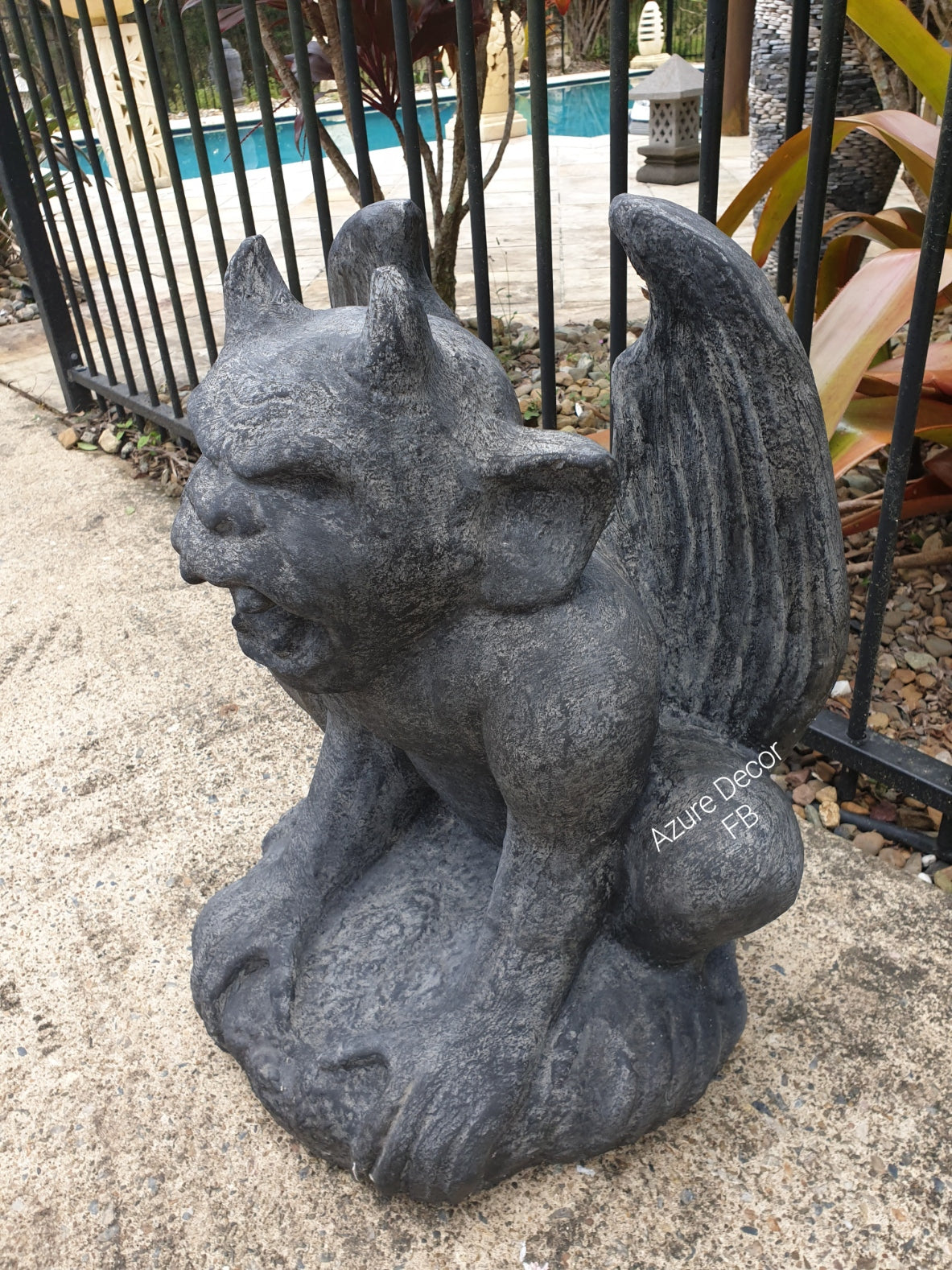 A rustic style gargoyle garden statue made from reinforced concrete and glass fiber, displayed in a natural outdoor setting.