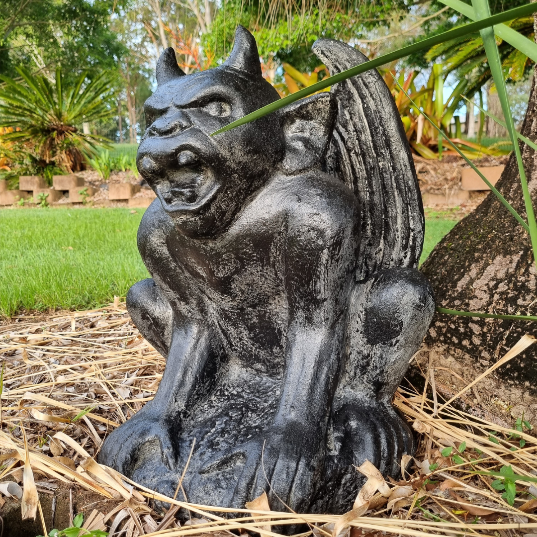 A rustic style gargoyle garden statue made from reinforced concrete and glass fiber, displayed in a natural outdoor setting.