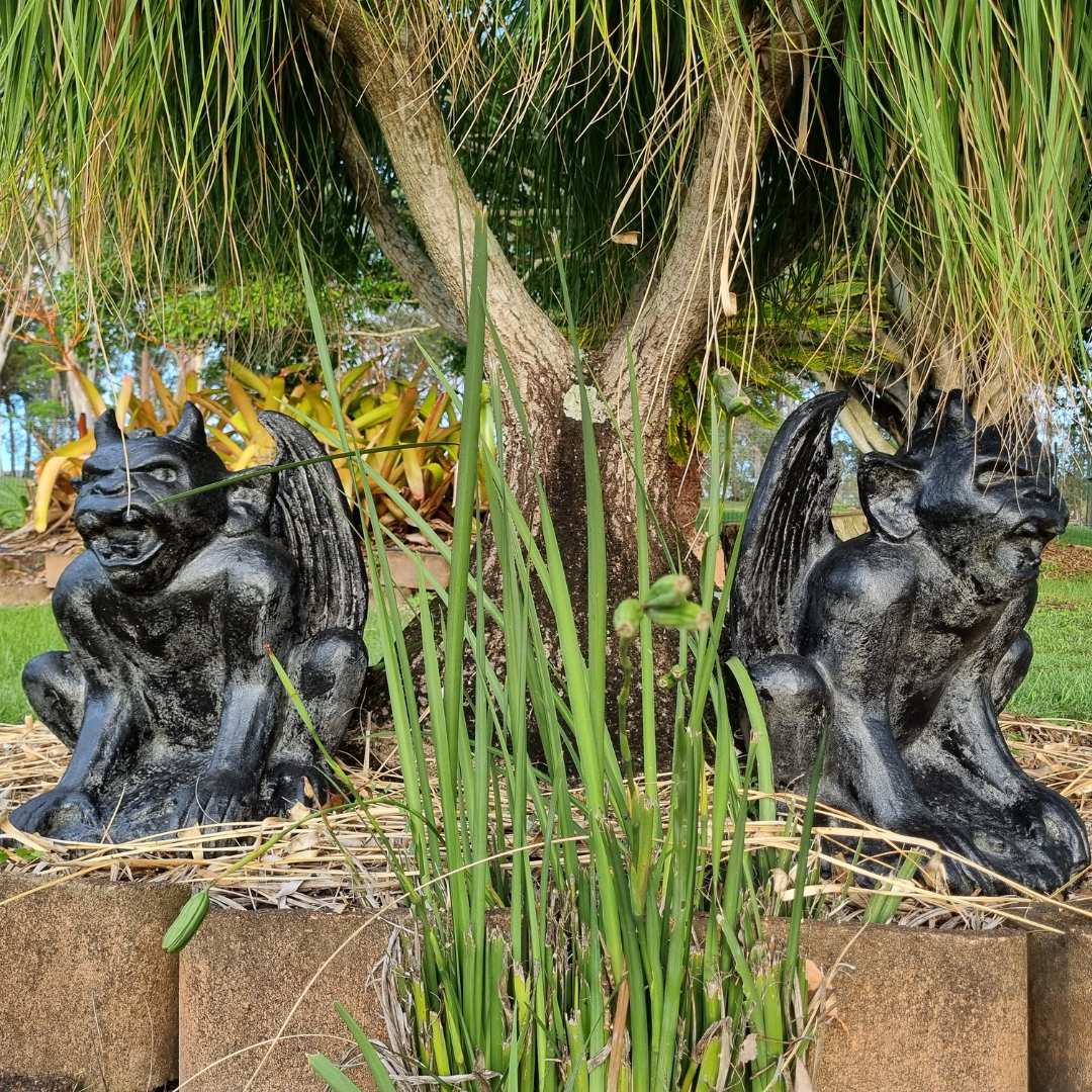 A rustic style gargoyle garden statue made from reinforced concrete and glass fiber, displayed in a natural outdoor setting.